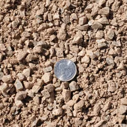 A close-up view of crushed Amaretto gravel, suitable for drainage systems and preventing soil erosion in landscaping projects.