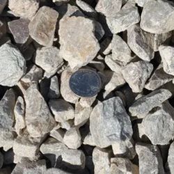 A close-up view of angular gravel in various sizes and shades, including earthy tones of brown and beige, providing a versatile option for landscaping projects and outdoor hardscapes.