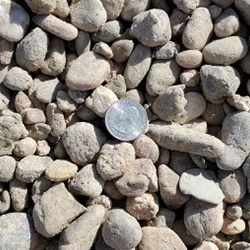 Gray Round 1 inch gravel, a versatile and durable landscaping material, available at Albuquerque Landscape Supply. This high-quality gravel features a rounded shape and a beautiful gray color, ideal for creating a natural and visually appealing outdoor space. Use this gravel to construct pathways, garden beds, or as a decorative element to enhance your landscape design.