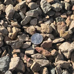 Mist 7/8 inch gravel, featuring a captivating blend of stones in soft gray tones, accompanied by a quarter for size reference. Available at Albuquerque Landscape Supply, this high-quality gravel adds a touch of elegance to outdoor projects. Use it for pathways, garden features, or as a decorative element to create a serene and sophisticated atmosphere in your landscape design.
